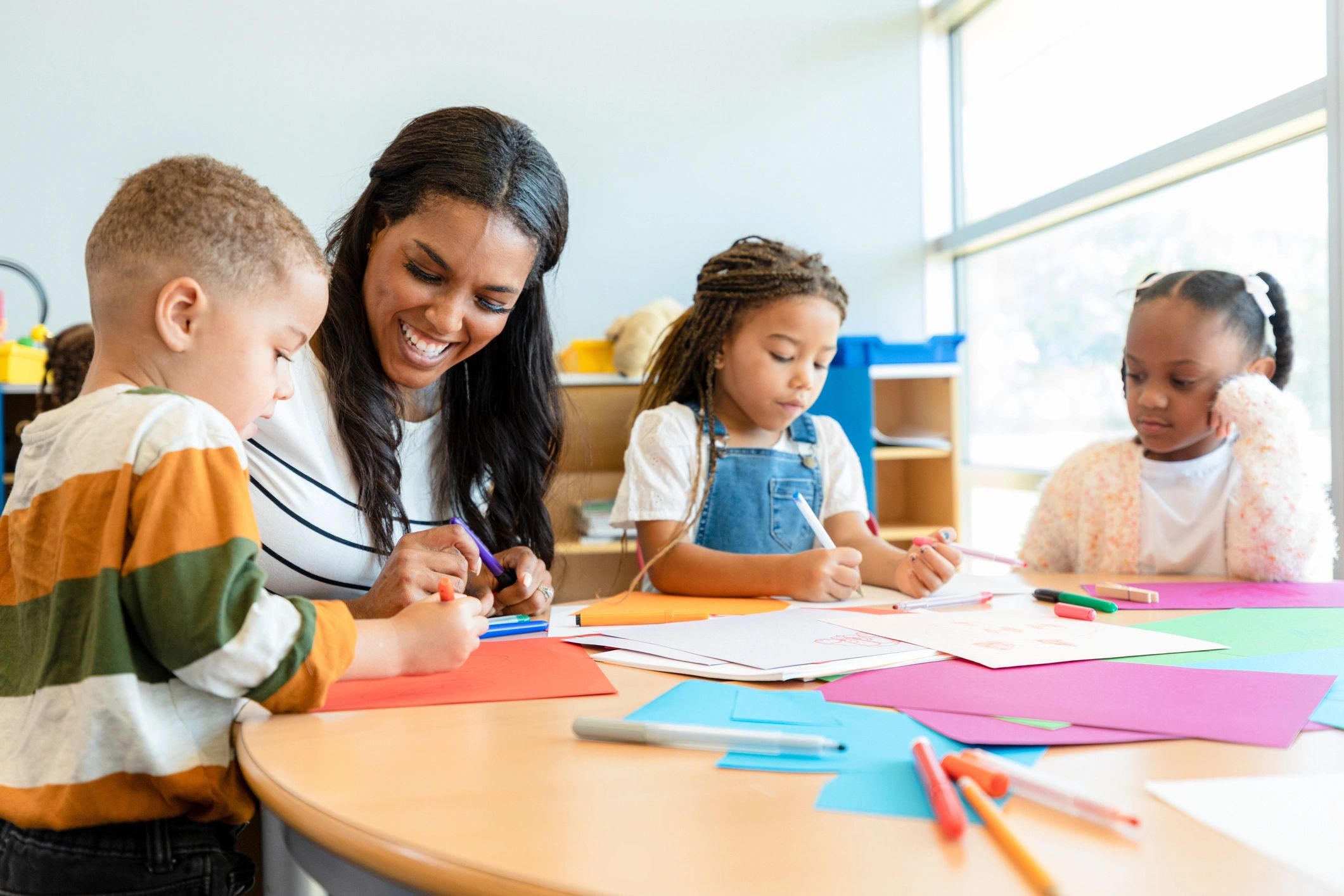 Teacher smiling at a child's artwork