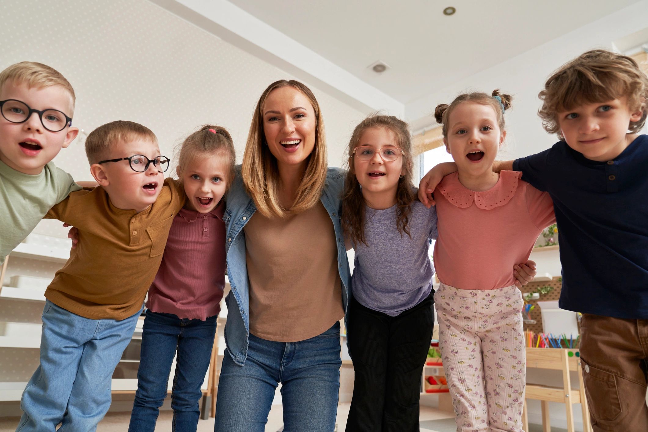 Preschool teacher with a group of children in a classroom
